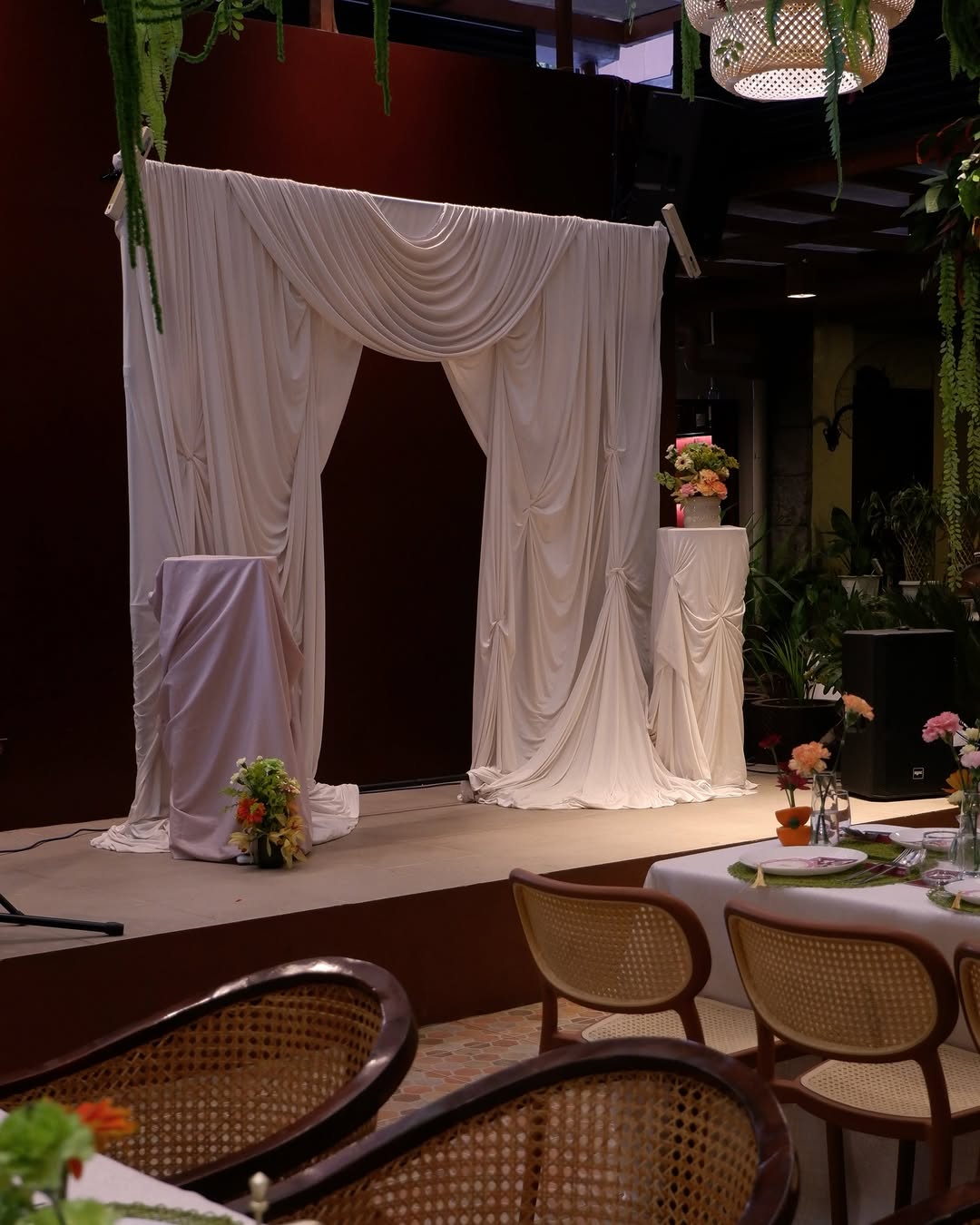 AMBAI live music stage with white drapes and warm lighting